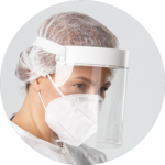 A woman wearing a protective clear face shield and white disposable respiratory mask