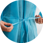 A doctor attaching his disposable gown