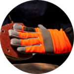 Heavy duty orange work gloves on hand