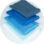 A pile of blue microfiber cloths used for cleaning and dusting