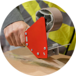 Worker sealing cardboard box with packaging tape dispenser