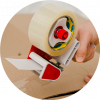 A hand packing a box with clear tape
